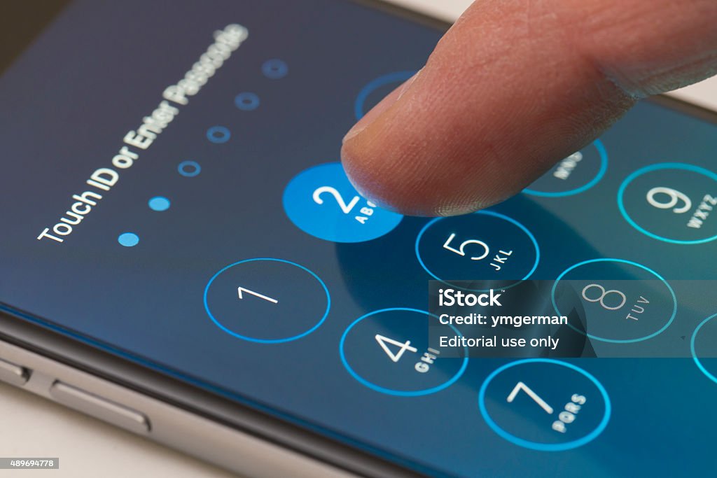 Enter passcode screen of an iPhone running iOS 9 Melbourne, Australia - Sep 24, 2015: Entering passcode on an iPhone running iOS 9.  This new iOS release has six digits passcodes instead of four. Unlocking Stock Photo