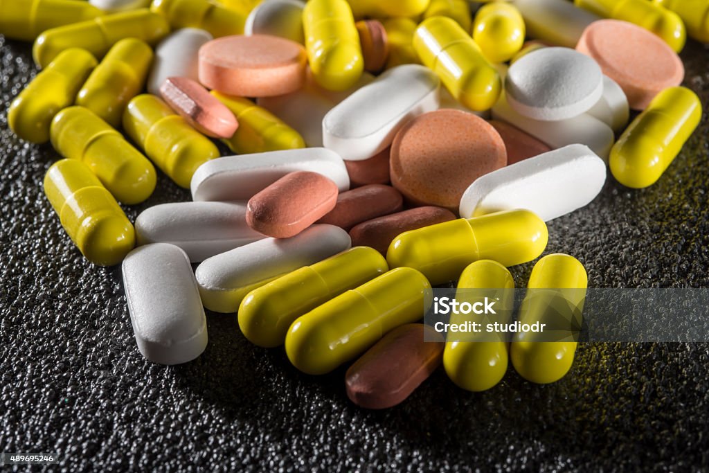 Stack of different colorful pills Stack of different colorful pills  2015 Stock Photo