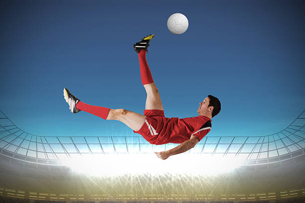 istock Football player in red kicking 489696551