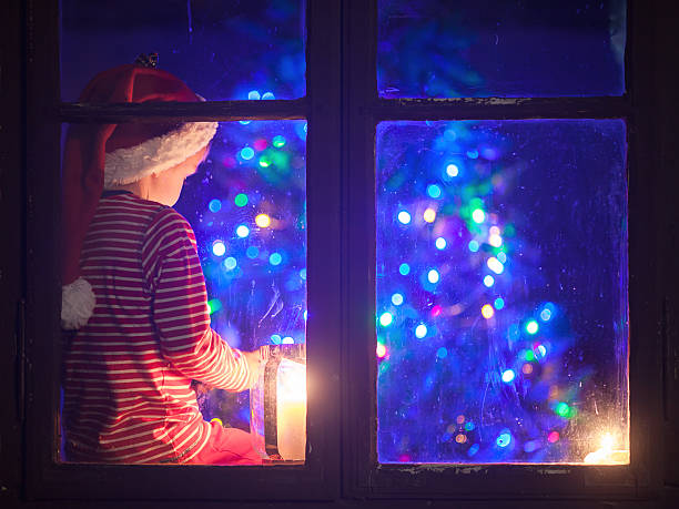 istock Cute boy, sitting on window shield, playing on mobile phone 489697178
