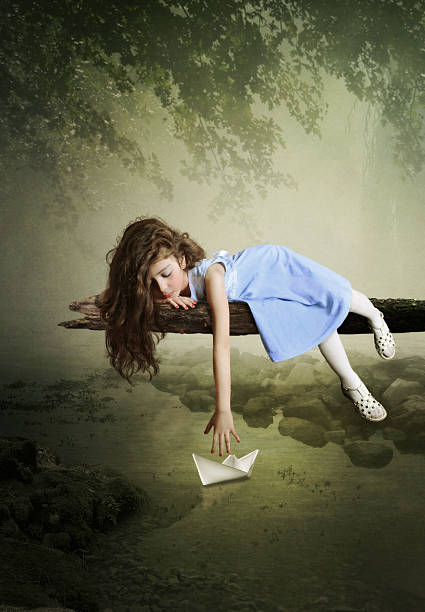 istock Girl and paper boat 489697473