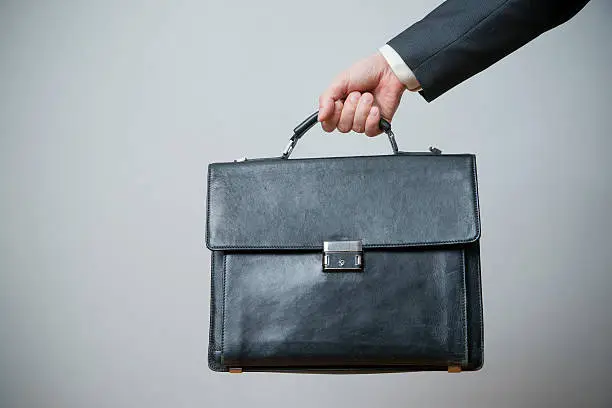 Photo of Businessman with briefcase in hand