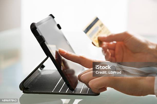 Woman Shopping Using Tablet Pc And Credit Card Indoorcloseup Stock Photo - Download Image Now