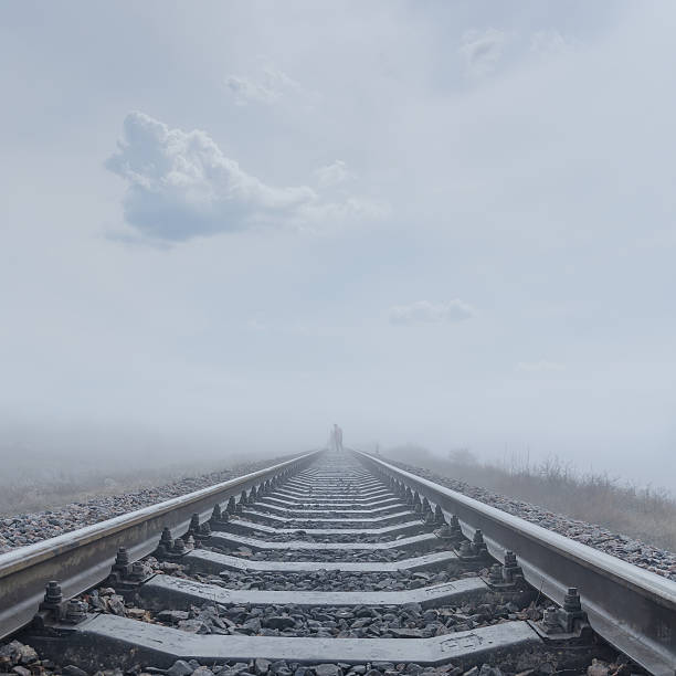 istock railroad to horizon in fog 489697887