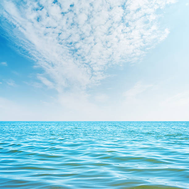 istock white clouds in sky and blue sea 489697904