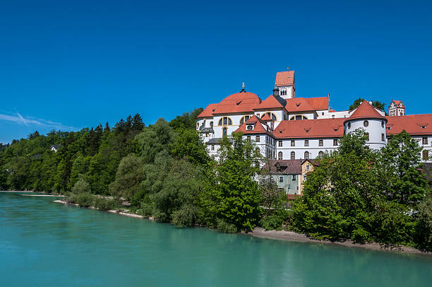 St Mang Abbey and Basilica, Lech River, Fussen, Bavaria, Germany St Mang's Basilica and St Mang Abbey on the River Lech, Fuessen, Bavaria, Germany. Benedictine monastery, st mang stock pictures, royalty-free photos & images