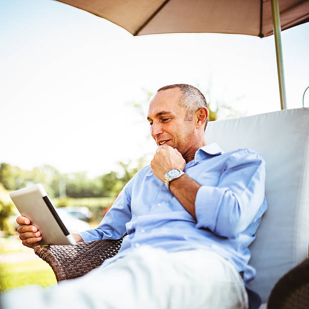 istock man relaxing with multimedia device at the resort 489698825