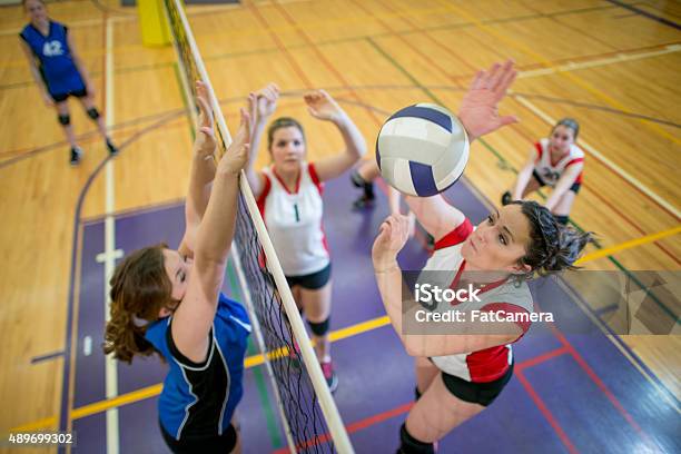 Women Spiking And Blocking A Volleyball Stock Photo - Download Image Now - Volleyball - Sport, Volleyball - Ball, High School