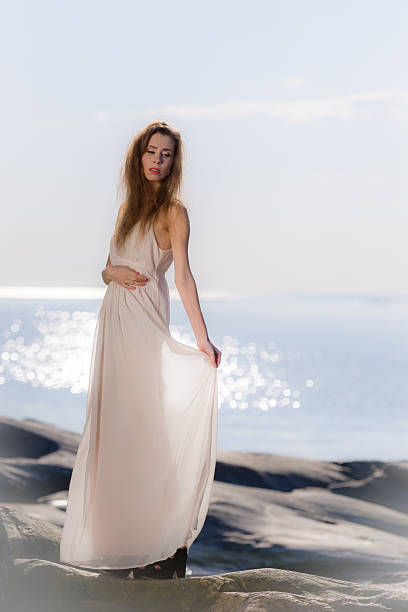 istock Young woman on rocky shore 489699405