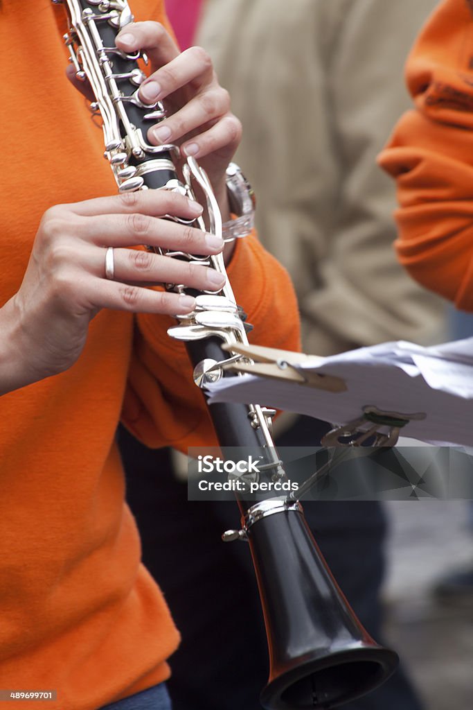 Playing clarinet Close up of clarinet and musician hands in an outdoors concert. Brass Band Stock Photo