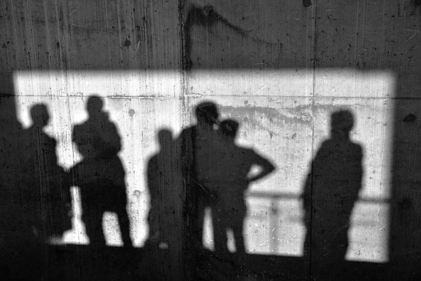 schatten auf der betonwand - schatten im mittelpunkt stock-fotos und bilder