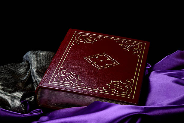 istock Deep Maroon Vintage Book on Purple Satin on Black 489700980