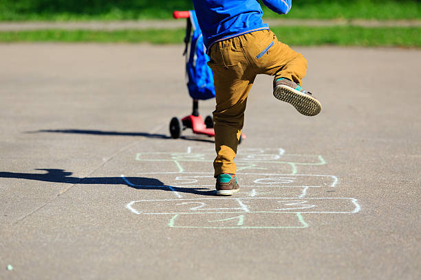 istock little boy playing hopscotch on playground 489723042