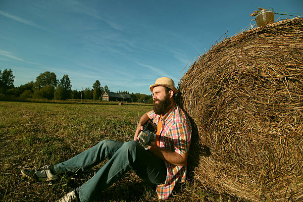 istock man with guitar and beer on the nature 489724330