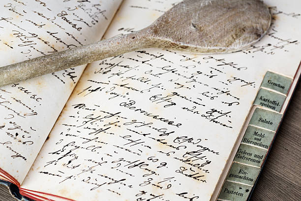 istock Old recipe book with wooden spoon 489724796