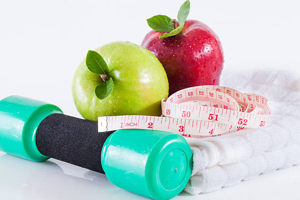 istock Apple and weights with measuring tape 489728500