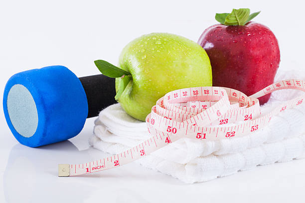 istock Apple and weights with measuring tape 489728754