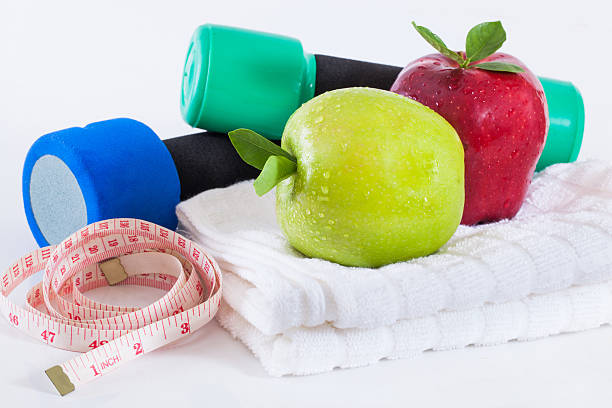 istock Apple and weights with measuring tape 489729040