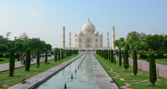 Agra, India - July 13, 2015: People visit Taj Mahal in Agra, India. The Taj Mahal is a mausoleum located in Agra, India and is one of the most recognizable structures in the world.