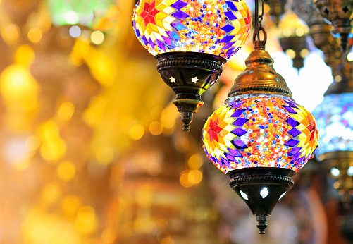 Colorful Turkish hanging lights of different colors and sizes. Turkish mosaic lambs. glass mosaic lamp in grand bazaar. Hand made mosaic vintage ottoman lambs and bokeh.