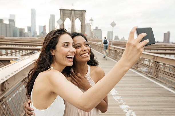 istock Tourist taking selfies on BRooklyn Bridge 489732802