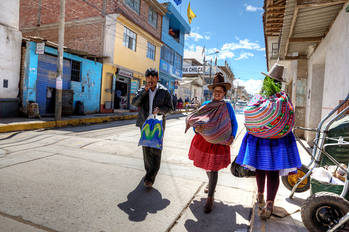 Yungay, Peru - January 25, 2015: Traditional Campesinas couple of Peru wearing distinctive hat and clothing shopping at street market on street in Yungay