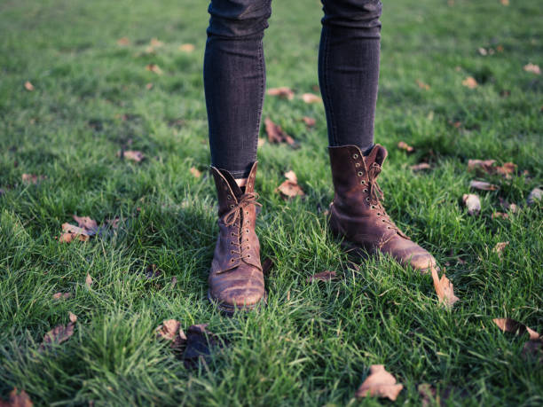 istock Legs of person standing on the grass 489734080