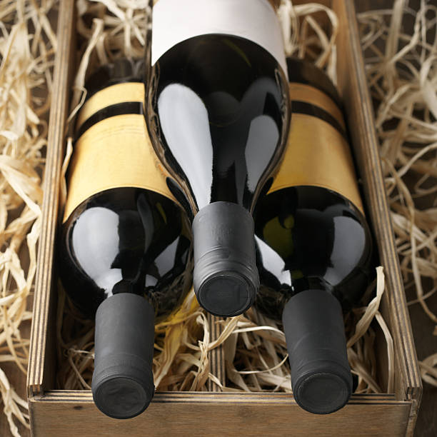 istock Wine bottles in wooden box and straw 489734814