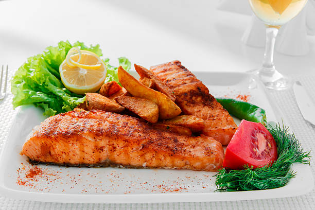 istock fried fish fillet of salmon with potatoes 489734818