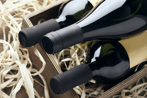 Wine bottles in wooden box and straw