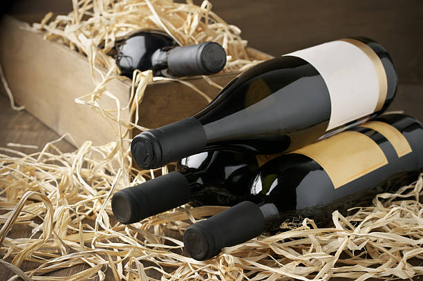 istock Wine bottles in wooden box and straw 489735618