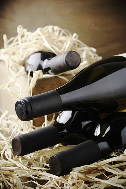 istock Wine bottles in wooden box and straw 489735656