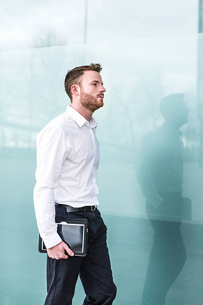 istock Businessman walking with digital tablet 489736412