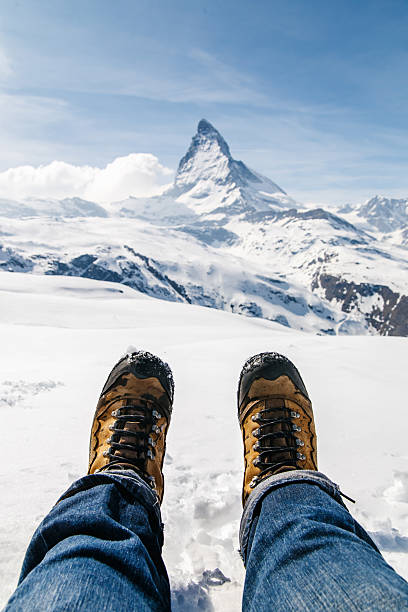 istock lying on the snow with boots at Matterhorn, Switzerland. 489737978