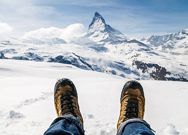istock lying on the snow with boots at Matterhorn, Switzerland. 489738146