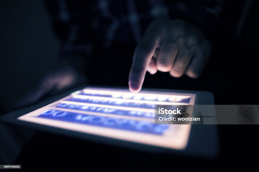 tablet use in the dark playing with a backlit tablet Internet Stock Photo