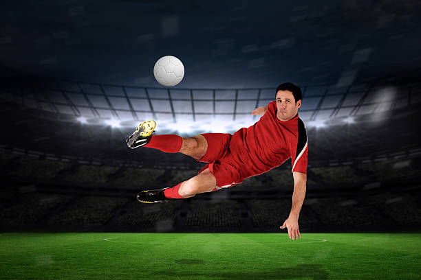 istock Football player in red kicking 489749595