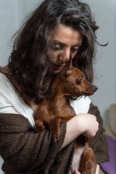 istock woman is holding her dog 489749609