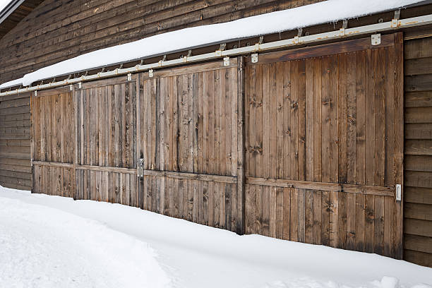 istock Old wooden barn door with snow 489751443