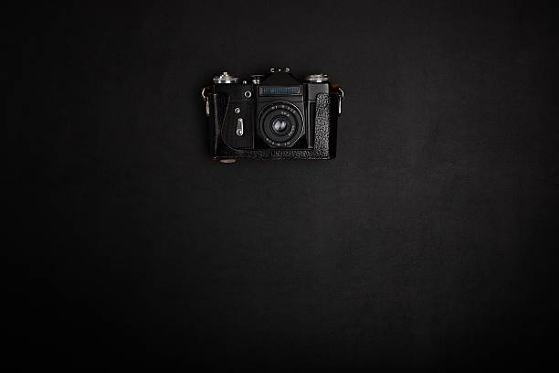 istock Vintage film camera on office table. Top view 489753454