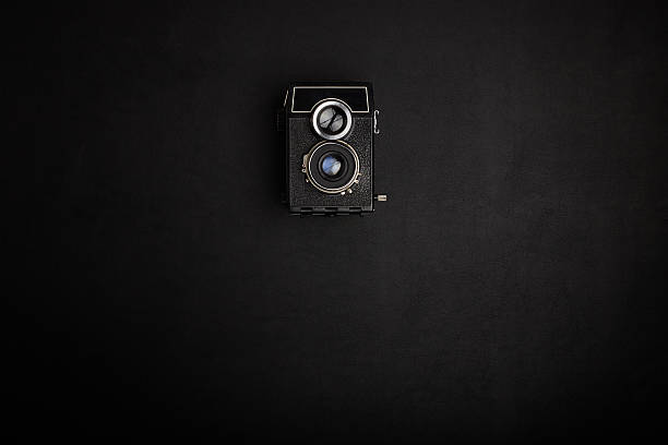 istock Vintage film camera on office table. Top view 489753848