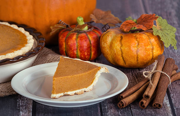 istock Slice of a pumpkin pie on wooden table 489754408