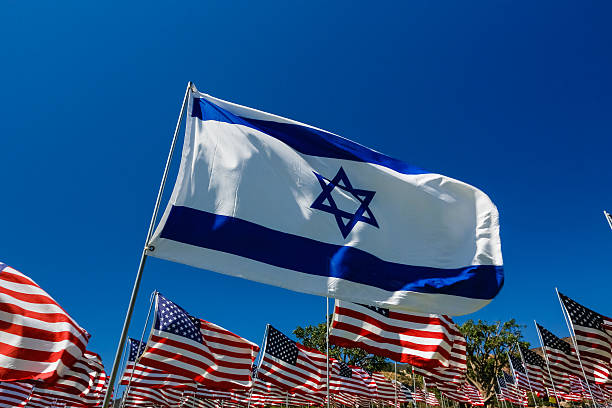 Israeli Flag in a Field of American Flags stock photo