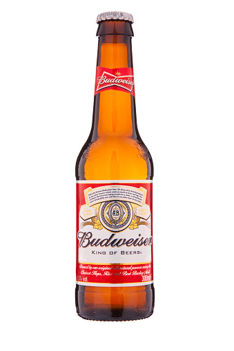 Dublin, Ireland - April 25, 2014: An isolated bottle of Budweiser beer with the signature red and white label, which is distributed by Anheuser-Busch Inc.