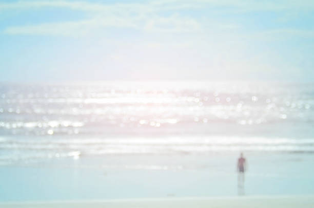 istock Blur man on beach with bokeh wave abstract background. 489756480