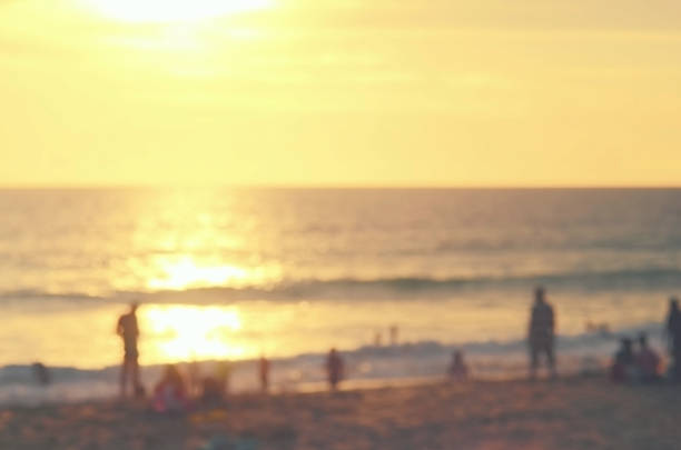 istock Blur people on sunset beach abstract background. 489757662