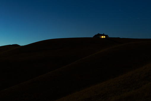A single house on a hilltop at nightfall in Clayton, California