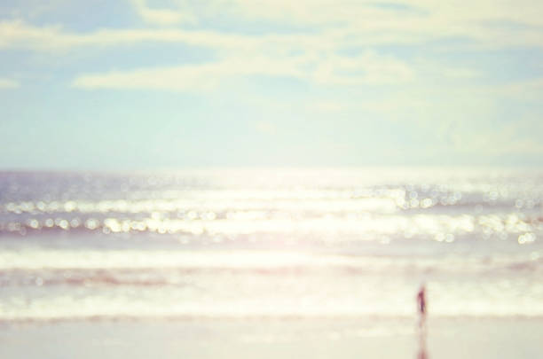 istock Blur man on beach with bokeh wave abstract background. 489759300