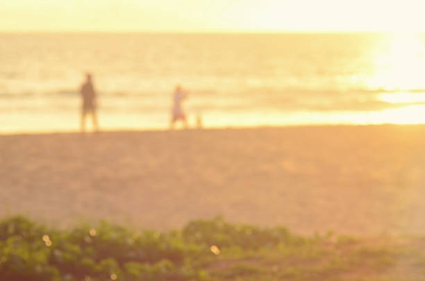 istock Blur people on sunset beach abstract background. 489759754