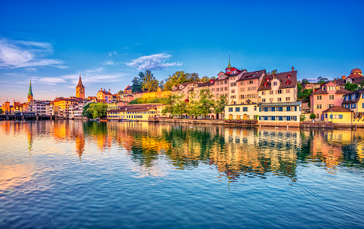 Sunrise in the historic downtown of Zurich at the Limmat River .